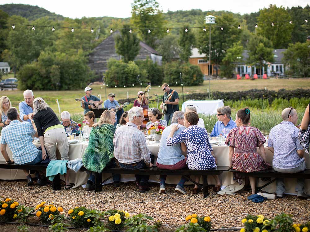 Farm dinner with many guests seated around a long table